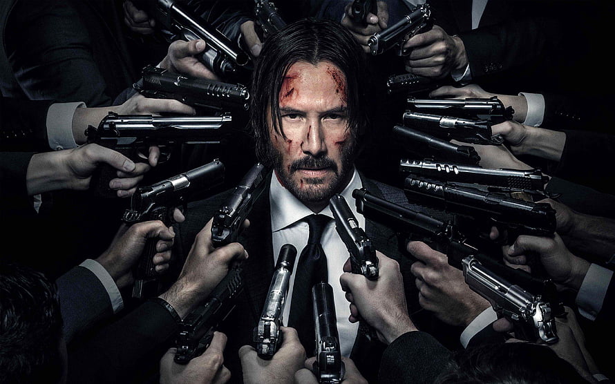 John Wick Surrounded by Guns in Dark Suit with Bloodied Face HD wallpaper