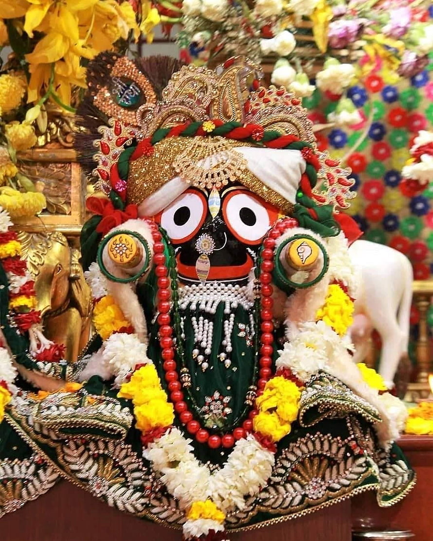 Lord Jagannath adorned in ornate gold crown, red beads, and vibrant floral garlands HD phone wallpaper