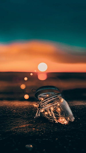 Glass Jar with Fairy Lights on a Beach at Sunset HD phone wallpaper