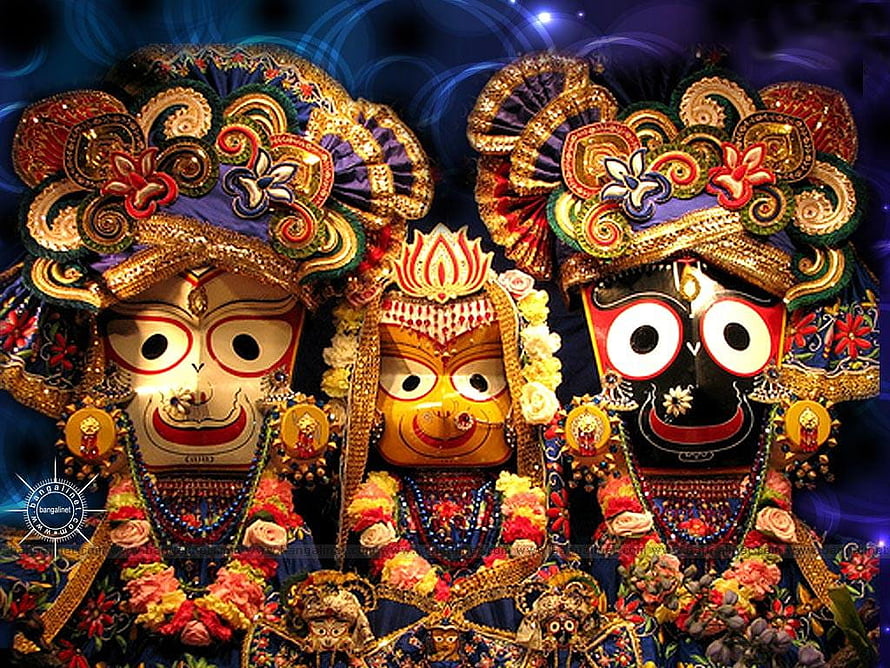 Sri Jagannath, Balabhadra, and Subhadra ornate wooden idols adorned with flowers and gold HD wallpaper