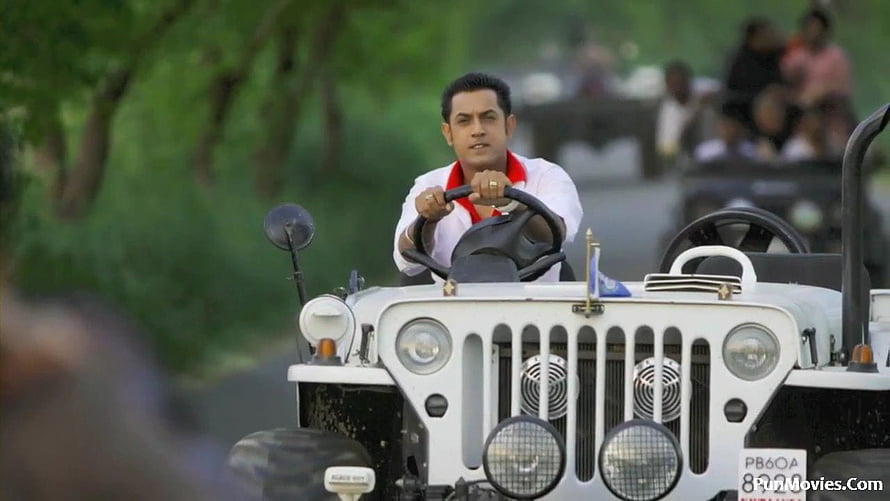 Sukha Kahlwan driving a white vintage jeep through a lush green forest road HD wallpaper