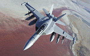 F-18 Super Hornet Fighter Jet In Flight Over Desert Terrain HD wallpaper