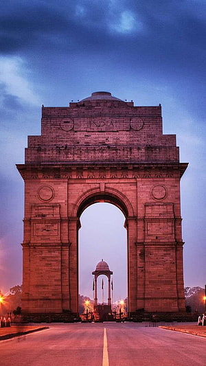 India Gate Monument in New Delhi at Dusk with Dramatic Sky and Warm Lighting HD phone wallpaper
