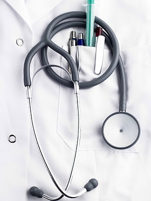 Stethoscope and medical instruments resting on a white doctor's lab coat HD phone wallpaper