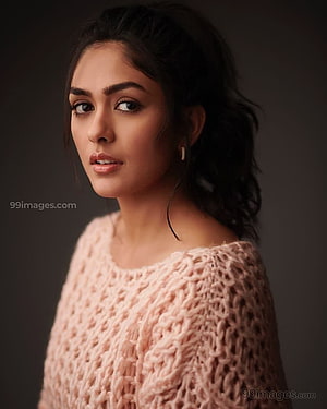 Mrunal Thakur in a Soft Pink Knit Sweater with Dark Studio Backdrop HD phone wallpaper