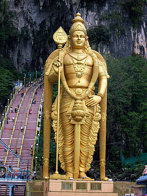 Lord Murugan Golden Statue at Batu Caves with Long Staircase and Limestone Cliffs HD phone wallpaper