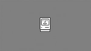 Classic Macintosh Computer Icon on Gray Background HD wallpaper
