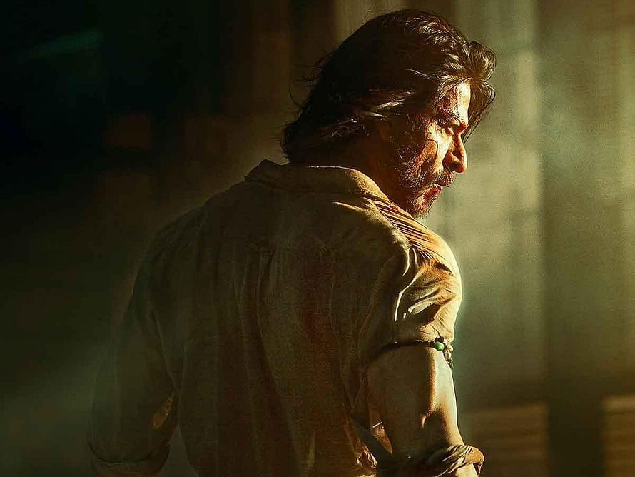 Shah Rukh Khan in dramatic profile from Pathaan with intense cinematic lighting HD wallpaper