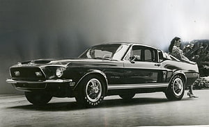 Vintage Ford Mustang Fastback with Model in Black and White Studio Photography HD wallpaper