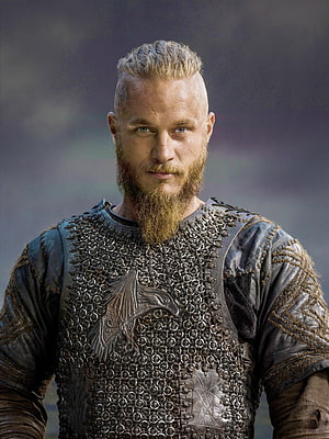 Ragnar Lothbrok in Viking Chainmail Armor with Eagle Emblem and Distinctive Beard HD phone wallpaper