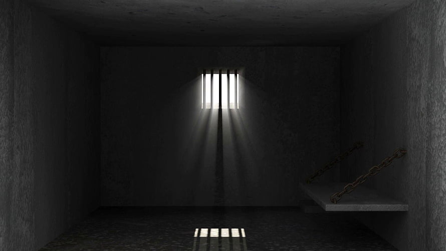 Dark Prison Cell Interior with Barred Window and Hanging Chains HD wallpaper