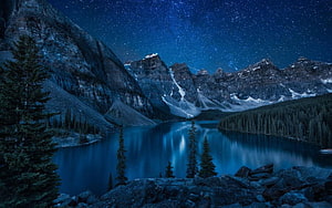 Moraine Lake at Night Under a Starry Sky in Banff National Park, Canada HD wallpaper