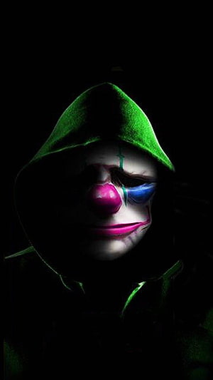 Green Hooded Criminal with Clown Makeup in Dark Portrait HD phone wallpaper