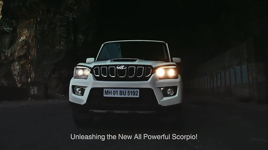 White Mahindra Scorpio Front View with Headlights On in a Dark Tunnel HD wallpaper