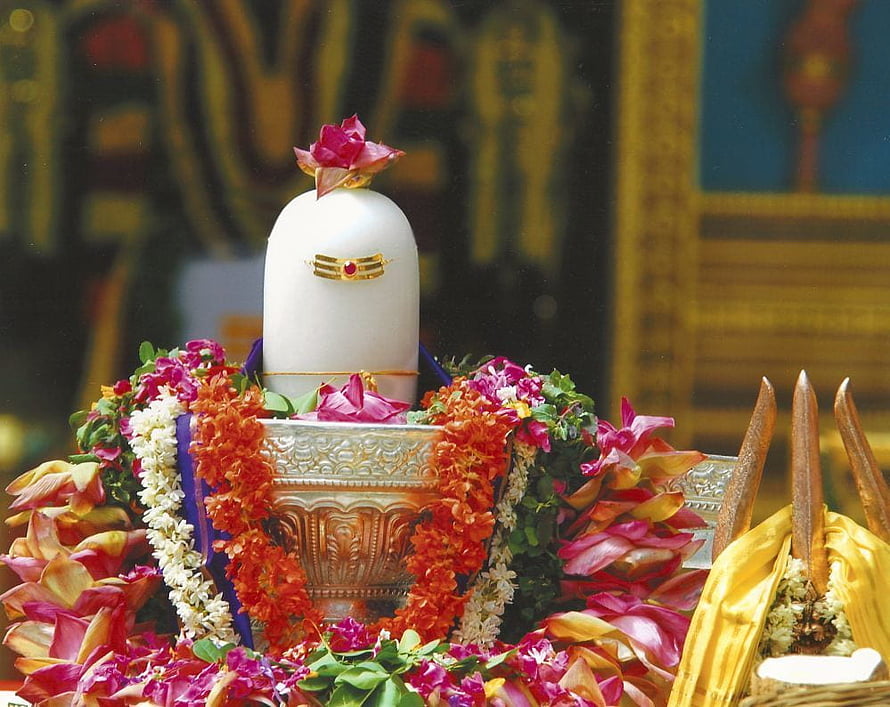 Adorned Shiva Lingam with Floral Garlands and Temple Decorations HD wallpaper