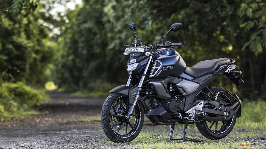 Yamaha FZS V3 Motorcycle Parked on a Gravel Path Surrounded by Lush Green Trees HD wallpaper
