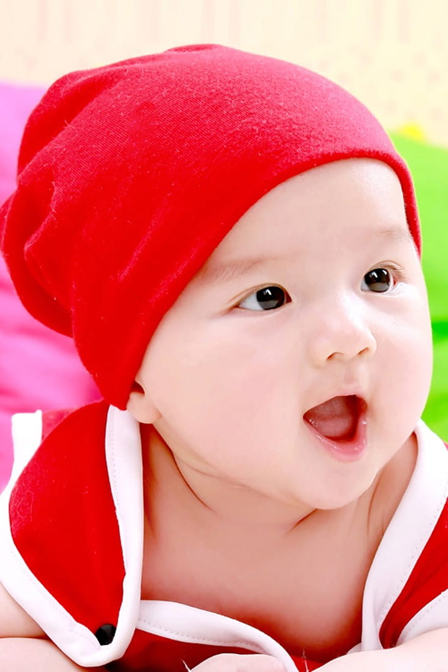 Adorable Baby Wearing a Red Knit Hat and Matching Outfit HD phone wallpaper