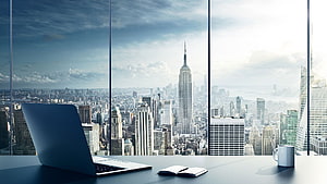 Modern Office Desk with Laptop and Notebook Overlooking New York City Skyline HD wallpaper