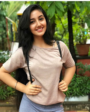 Smiling Young Woman with Long Dark Hair in a Casual Beige Top and Blue Skirt HD phone wallpaper