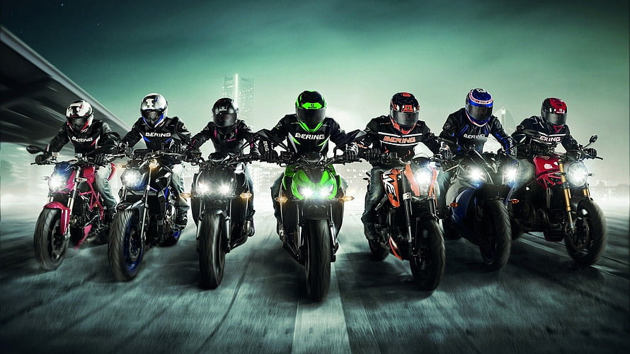 Seven Motorcyclists Riding Sport Bikes in a Line on a City Street at Night HD wallpaper