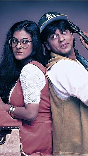 Shah Rukh Khan and Kajol in Dilwale promotional portrait with guitar and retro styling HD phone wallpaper
