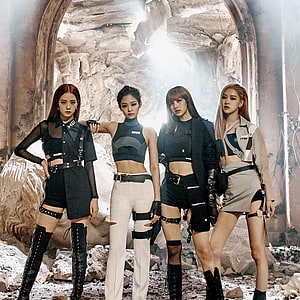 Blackpink in edgy tactical outfits posing in a ruined stone archway with dramatic backlighting HD phone wallpaper
