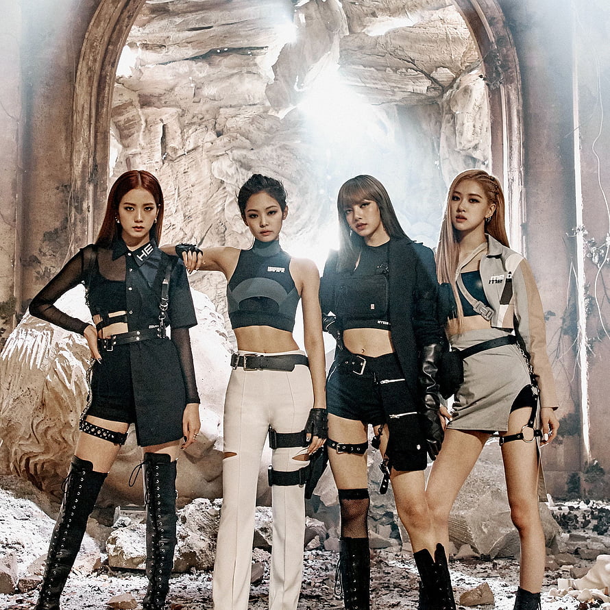 Blackpink in edgy tactical outfits posing in a ruined stone archway with dramatic backlighting HD phone wallpaper