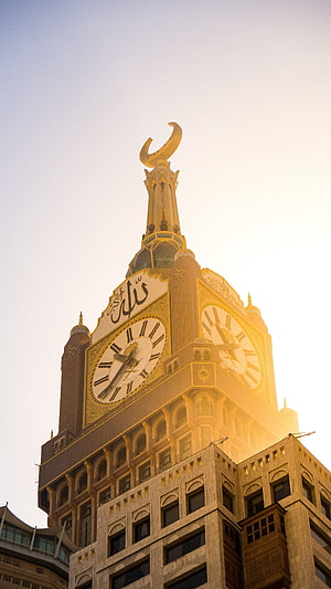 Makkah Clock Tower at Golden Hour with Crescent Spire and Arabic Calligraphy HD phone wallpaper