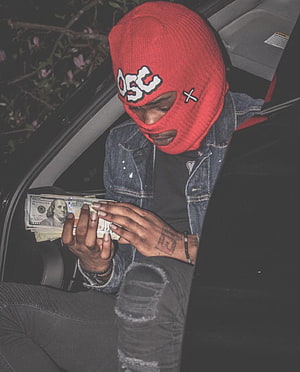 Man in red ski mask counting cash inside a car at night HD phone wallpaper