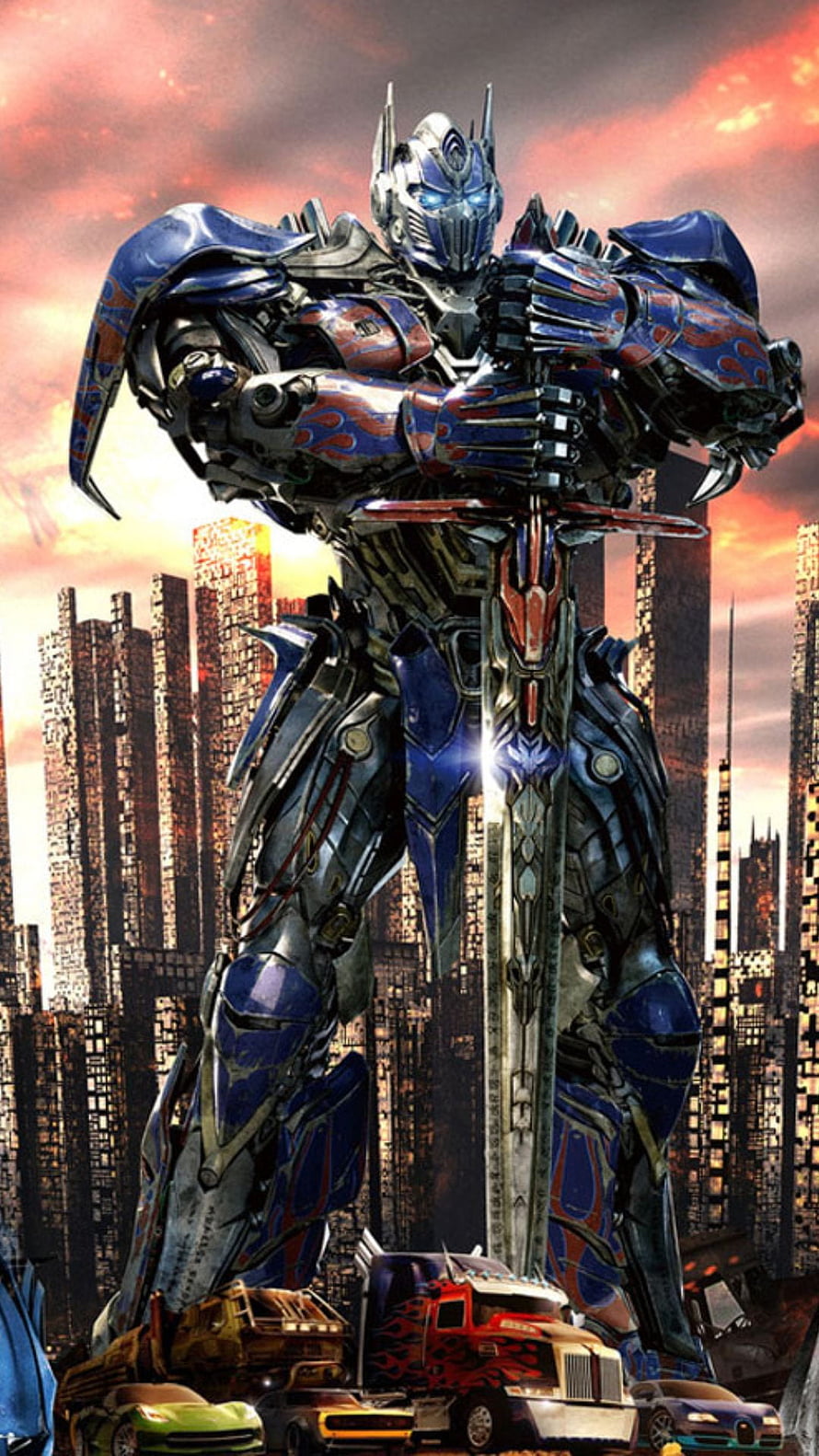 Optimus Prime Standing Over Destroyed City with Sword and Vehicles HD phone wallpaper
