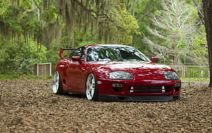 Red Toyota Supra MK4 Stance Build Parked in a Lush Forest Clearing HD wallpaper