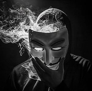 Anonymous Guy Fawkes Mask Portrait with Dramatic Smoke and Glowing Eyes HD wallpaper