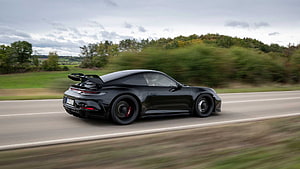 Black Porsche 911 GT3 992 Driving on a Country Road with Motion Blur HD wallpaper
