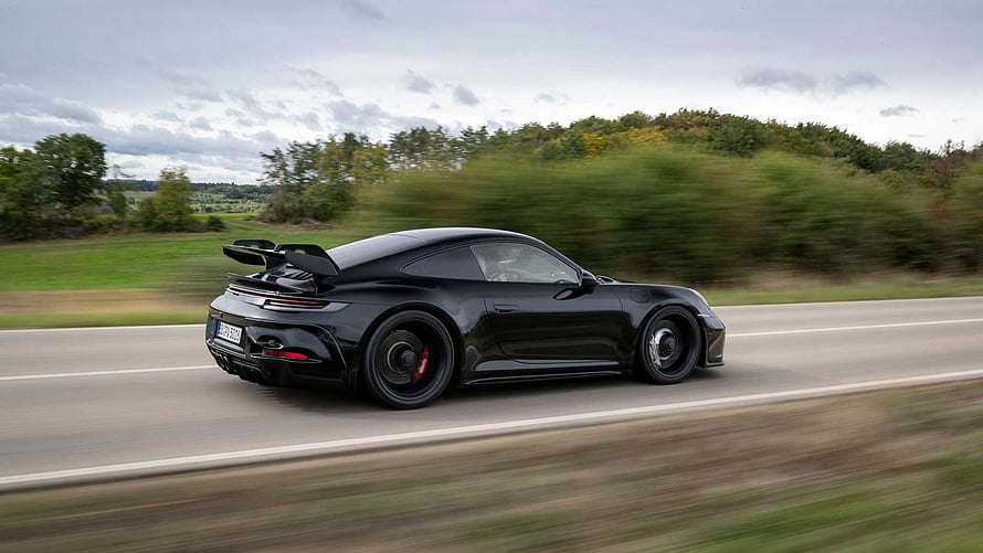 Black Porsche 911 GT3 992 Driving on a Country Road with Motion Blur HD wallpaper