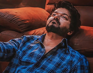 Vijay in Master Film Reclining on Leather Sofa in Blue Plaid Shirt HD wallpaper