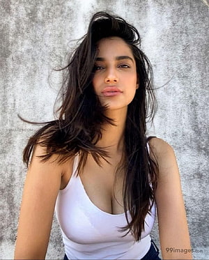 Meenakshi Chaudhary Portrait in White Tank Top with Windblown Hair HD phone wallpaper