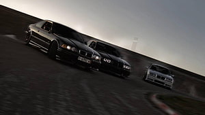 Three BMW E36 sedans drifting on a racetrack at dusk with motion blur and dramatic lighting HD wallpaper