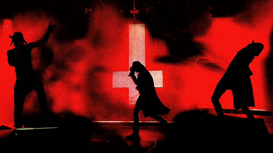 Silhouetted Performers on Stage with Red Lighting and Cross Backdrop HD wallpaper