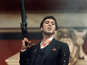 Tony Montana in Scarface Holding a Shotgun in a Pinstripe Suit HD wallpaper