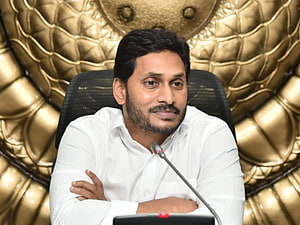 YS Jagan Mohan Reddy Seated at Press Conference with Microphone Against Gold Quilted Backdrop HD wallpaper