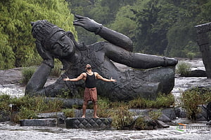 Raavanan Movie Still: Man Standing Before Giant Reclining Statue in River, Raavanan Stills and , & Moviestills, #raavanan HD wallpaper