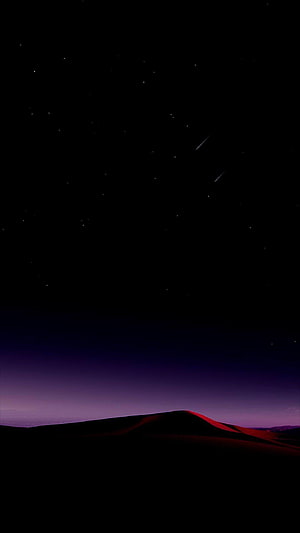 Dark Night Sky with Shooting Stars Over Silhouetted Desert Dunes HD phone wallpaper