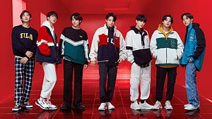 BTS Members in Colorful FILA Streetwear Against a Vibrant Red Studio Backdrop HD wallpaper