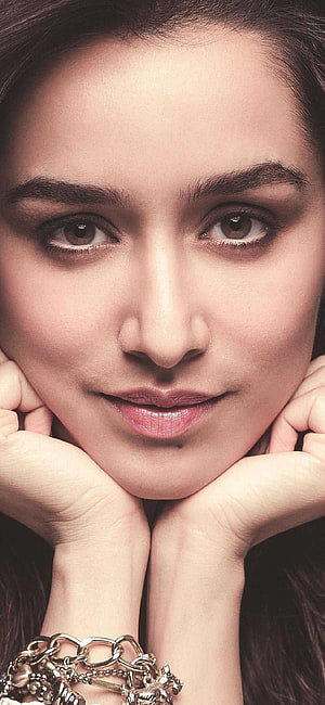 Shraddha Kapoor Close-Up Portrait with Hands Framing Face and Silver Charm Bracelet HD phone wallpaper