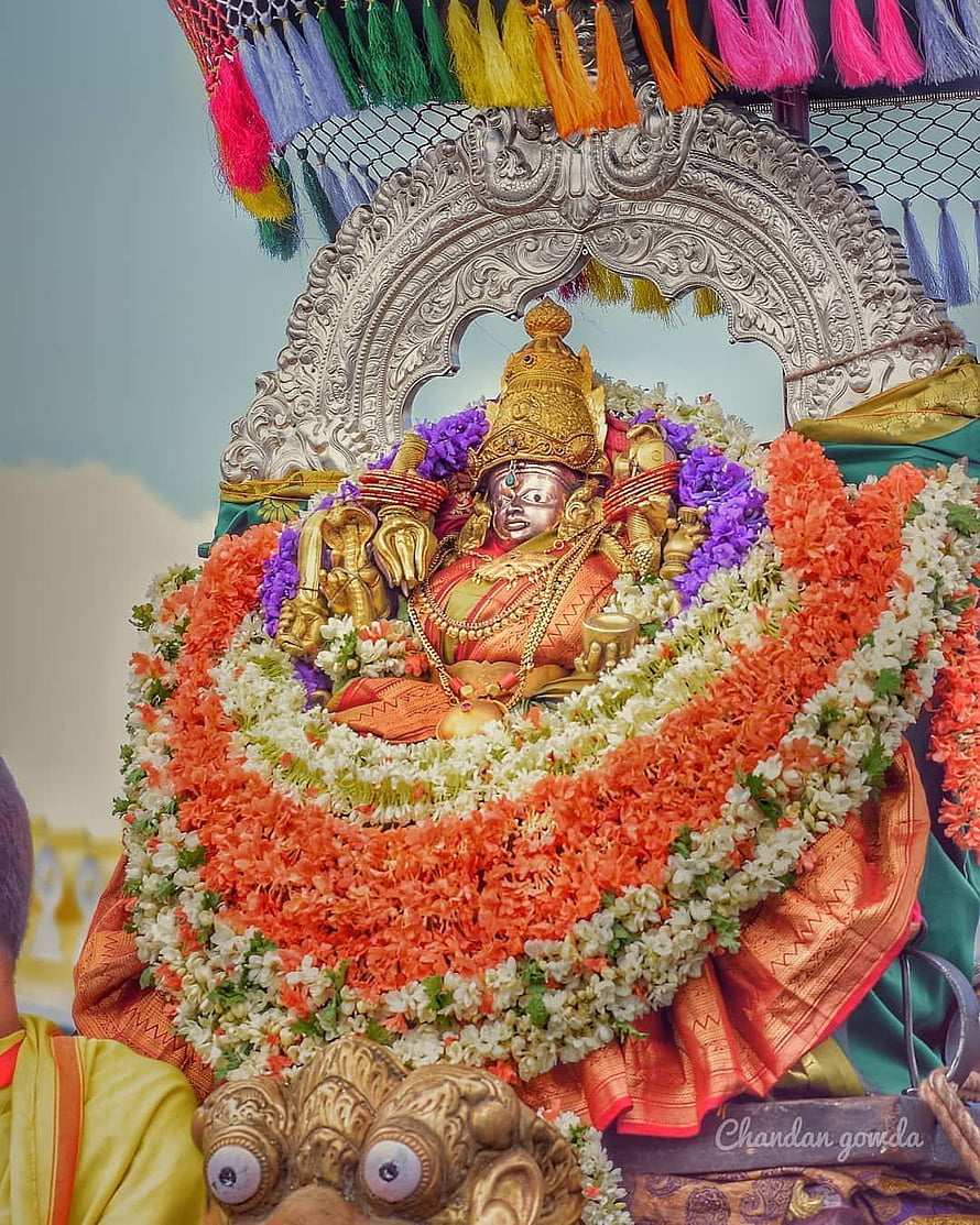 Chamundeshwari deity adorned with vibrant floral garlands and ornate silver archway HD phone wallpaper