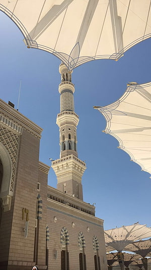 Nabawi Mosque Minaret and Canopy in Medina Under a Clear Blue Sky HD phone wallpaper