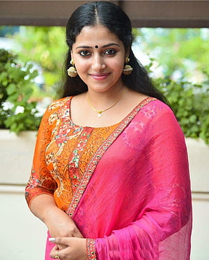 Anu Sithara in Vibrant Orange and Pink Traditional Indian Attire HD phone wallpaper