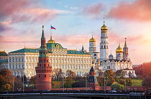 Moscow Kremlin at Golden Hour with Red Square Towers and Russian Flag HD wallpaper
