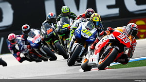 MotoGP Riders Cornering at Full Speed on the Racing Circuit HD wallpaper