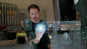 Tony Stark Interacting with Holographic Interface in Stark Tower HD wallpaper